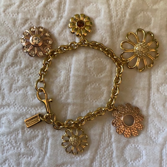 Coach gold daisy charm bracelet. New without tag.